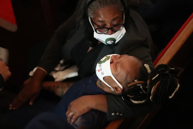 Dominique Wallace, wife of Walter Wallace Jr., is comforted during his funeral service inside the National Temple Baptist Church in Philadelphia on Saturday, Nov. 07, 2020. Wallace was shot and killed by Philly police on Oct. 26.