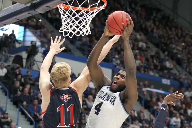 Eric Paschall, right, of Villanova shoots against Matthias Tass of St. Marys during the 2nd half action in a first round NCAA Tournament game at the XL Center in Hartford, CT on March 21, 2019.