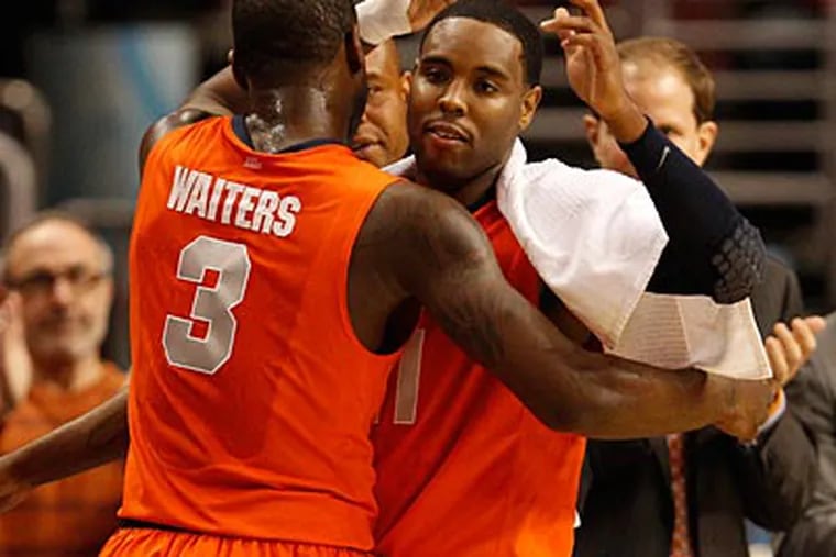 Syracuse's Scoop Jardine congratulates Dion Waters as he exits the game in the closing minutes. (Ron Cortes/Staff Photographer)
