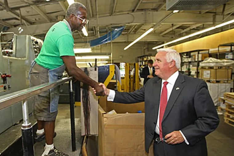 Republican gubernatorial candidate Tom Corbett shakes hands with employee William McNair while touring the Archway Printing plant in Sharon Hill on Tuesday. (Michael Bryant / Staff Photographer)