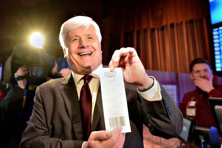 State Sen. Tommy Tomlinson (R., Bucks) is shown here holding a sports betting ticket at Parx Casino. Tomlinson’s office asked lobbyists for the casino to write language for a bill to ban skill games.