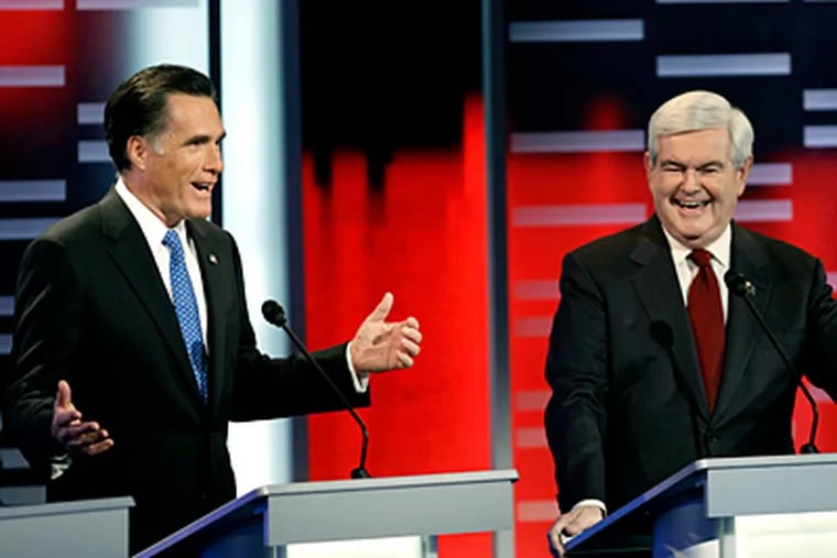 During the GOP presidential debate in Iowa, former Massachusetts Gov. Mitt Romney and former House Speaker Newt Gingrich trade remarks. The state’s caucuses are in early January. (Charlie Neibergall / Associated Press)