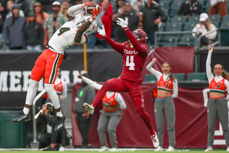 Miami wide receiver Colbie Young (left) makes a touchdown catch over Temple safety Tywan Francis in the first half Saturday at Lincoln Financial Field.