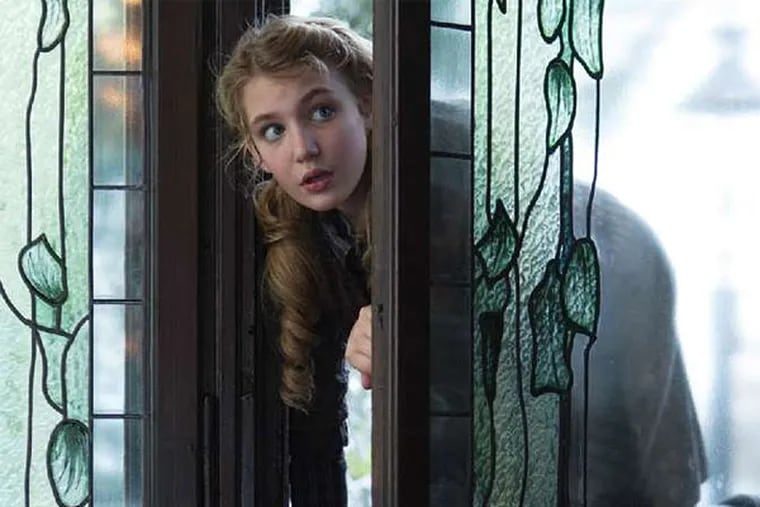 Liesel (Sophie N&#0233;lisse) sneaks into a neighbor's well-stocked library to pursue her love of reading in &quot;The Book Thief.&quot;