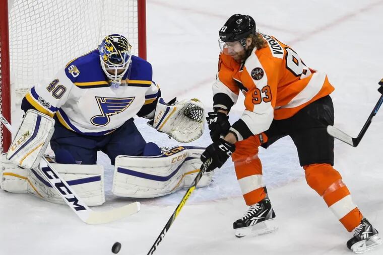 Jake Voracek tries to get to the puck in front of Blues goalie Carter Hutton during a game last season.