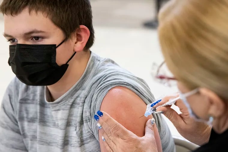 Braden Hardel, 14, of King of Prussia, gets vaccinated at the King of Prussia Mall in May.