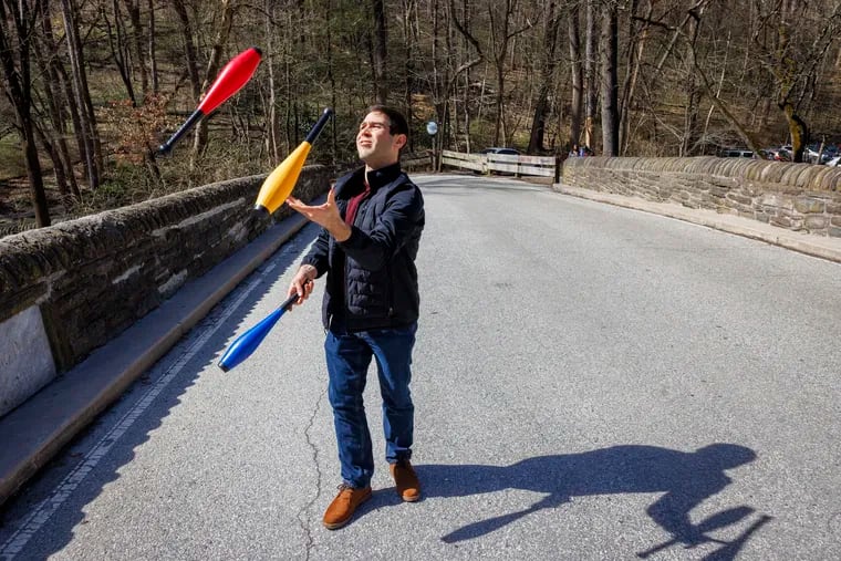 Julian Plotnick of Roxborough juggles on Forbidden Drive in Philadelphia on a Friday afternoon. Plotnick is an employee of Metropolitan Acoustics who works on a 4-day work week, with no work on Fridays. His individual experiment with the new work arrangement inspired his CEO to implement it for the whole company.