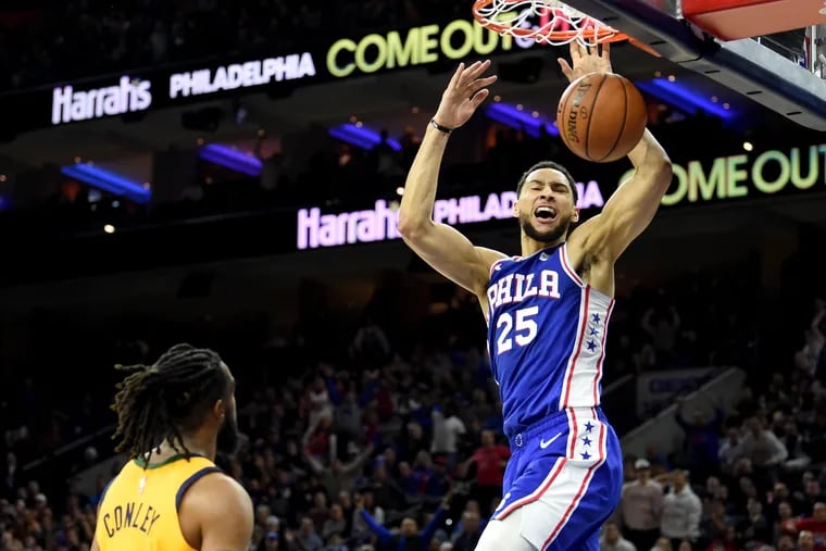Sixers guard Ben Simmons dunks in the first half above Mike Conley (left) of the Jazz at the Wells Fargo Center.