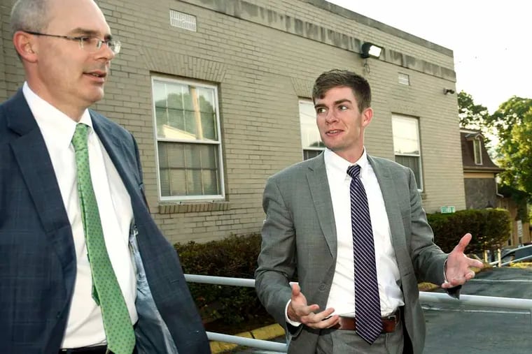 With his attorney Frank Fina at left, Beta Theta Pi fraternity president Brandon Young, 21, of Malvern, leaves his preliminary hearing in Bellefonte, Pa., on Monday after being charged with involuntary manslaughter and aggravated assault.