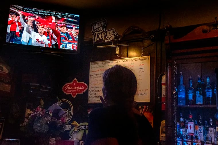 Doobies Bar owner Patti Brett, a huge Phillies fan, watches Game 3 of the World Series in her bar on Tuesday.