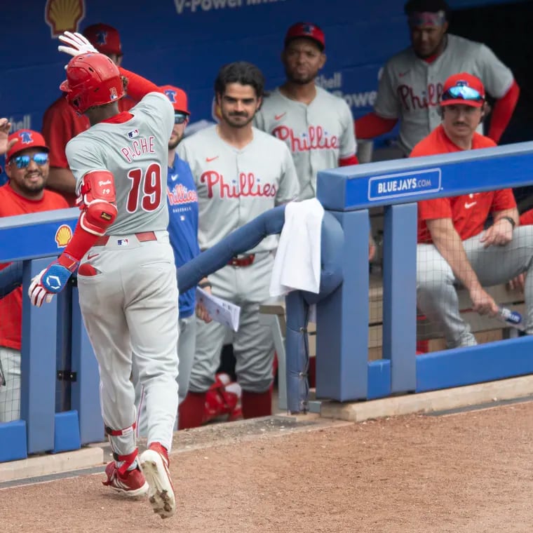 Phillies’ Cristian Pache is congratulated in the dugout by manager, Rob Thomson and teammates after a solo home run in sixth inning of the game against the Toronto Blue Jays on Thursday, Feb. 29, 2024, at TD Park in Dunedin, FL.