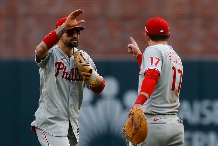 Phillies right fielder Nick Castellanos and first baseman Rhys Hoskins celebrate their 7-6 win over the Braves in Game 1.