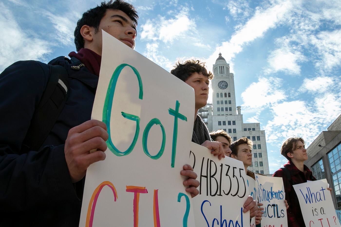 From left, Navid Verlin, Shane Cohen-Mungan, Ray Macdonald, Willem Cousineau, and Malcolm Margasak, all students at Masterman, attend a rally for more school libraries outside Philadelphia School District headquarters.