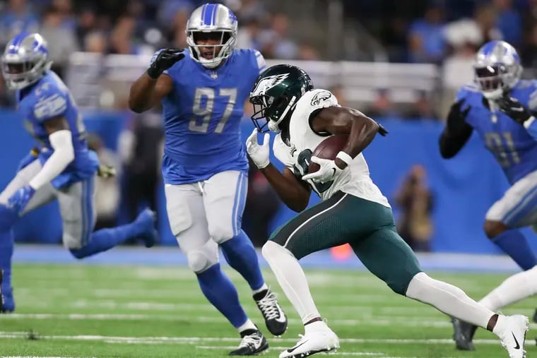 Eagles wide receiver Jalen Reagor runs with the football against Detroit Lions defensive end Nick Williams during the first quarter on Sunday, October 31, 2021 in Detroit.