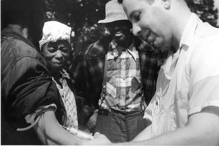 A doctor draws blood from a patient in the Tuskegee syphilis study, which helped create lingering distrust of clinical trials.