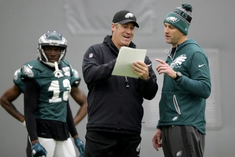 Eagles' head coach Doug Peterson, center, talks with wide receivers coach Mike Groh, right, as the Philadelphia Eagles practice during the bye week in Philadelphia, PA on January 3, 2018. The Eagles will host a playoff game on Saturday, January 13. DAVID MAIALETTI / Staff Photographer