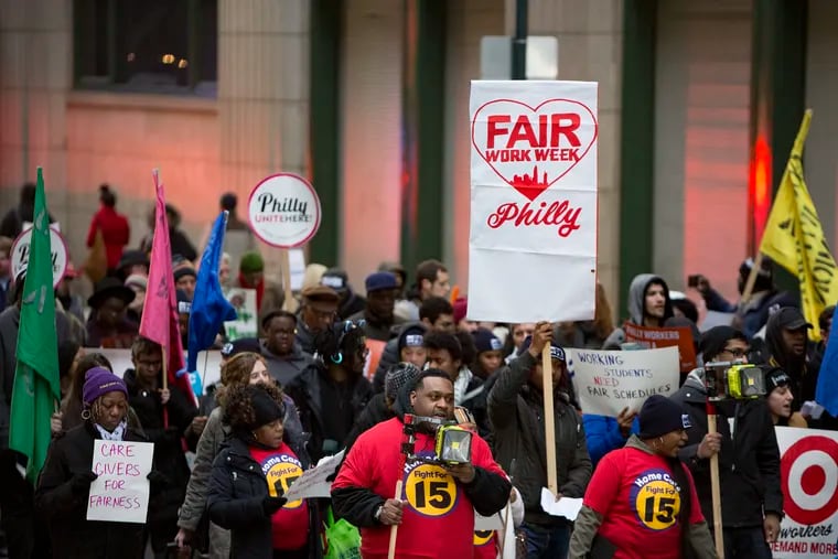 Fast food and retail workers march through Center City to kick off the campaign for "Fair Workweek" legislation in February 2018. It's one of three worker-protection laws the city will be in charge of enforcing in 2020.