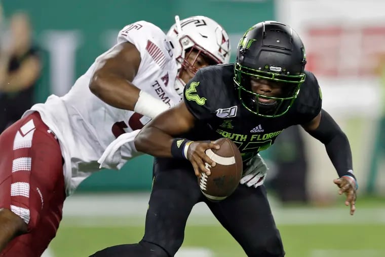 South Florida quarterback Jordan McCloud (12) eludes a sack by Temple defensive end Quincy Roche during the first half.