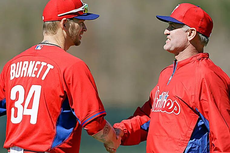 Phillies manager Ryne Sandberg and pitcher A.J. Burnett. (Charlie Neibergall/AP)
