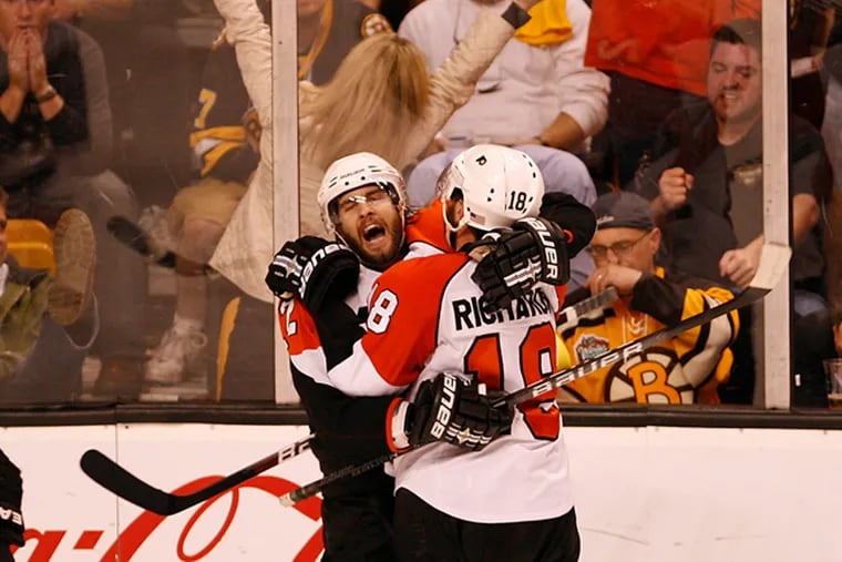Simon Gagne, left, and Mike Richards, right, celebrate what turned out to be Gagne's Game 7-winning goal.