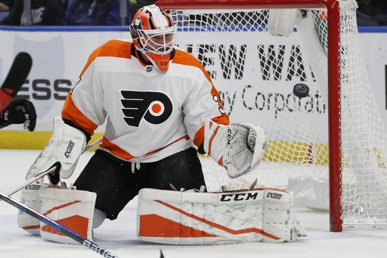 Flyers goalie Brian Elliott (37) keeps his eyes on the puck during the first period of an NHL hockey game against the Buffalo Sabres, Friday, Dec. 22, 2017, in Buffalo.