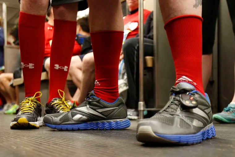 PHOTOS: DAVID MAIALETTI / STAFF PHOTOGRAPHER Runners on the subway (top left) sport their red socks. There was plenty of patriotism at start of the race. Mist from a fire hydrant covers runners along the 9-mile marker (below).