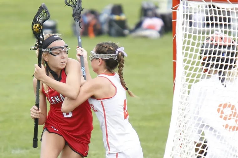 Lenape’s Lauren Figura (left) gets checked by Cherokee’s Olivia Singer last season. She left Saturday’s game due to injury.