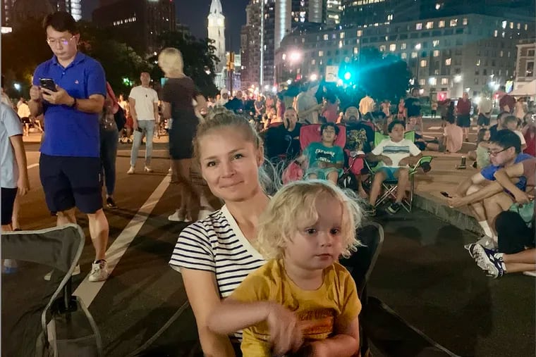 Zoe Bouchelle with her son on the Parkway on July Fourth, just before gunshots rang out. After they fled and got home, her son asked if they could “be safe again when the sun comes up.”