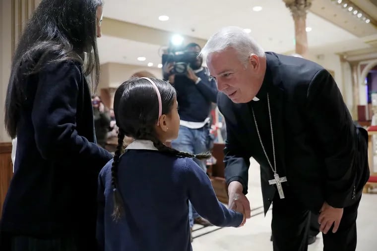 New Archbishop Nelson Pérez, right, greets St. Peter the Apostle School student Valentina Cuellar, 6, at the National Shrine of St. John Neumann on Friday.