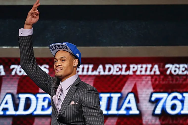 Clemson forward K.J. McDaniels motions to fans after being selected 32nd overall by the Philadelphia 76ers in the second round of the 2014 NBA draft, Thursday, June 26, 2014, in New York. (Jason DeCrow/AP)