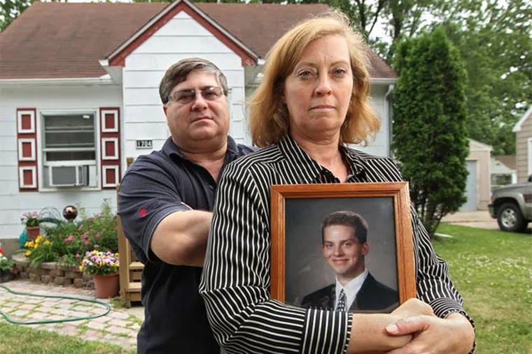 Terry Zabel, left, and Lana Zabel, right, with Beau's senior portrait in front of their home in Austin, Minn. ( MICHAEL BRYANT / Staff Photographer )