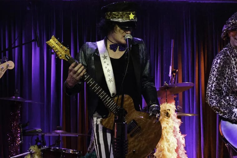 Timm Mulhern of Cowbell Spectacular plays guitar using a bejeweled prosthetic.