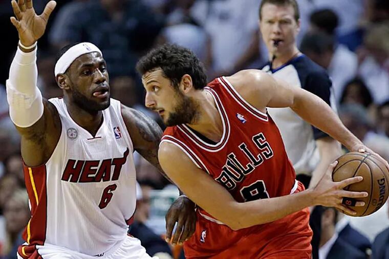 Miami's  LeBron James  guards Chicago's  Marco Belinelli. (Lynne Sladky / AP)