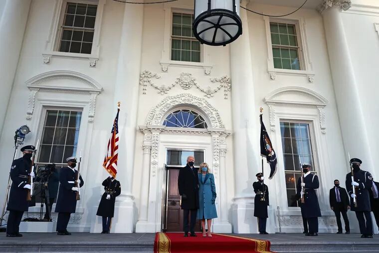 President Joe Biden and first lady Jill Biden stand at the North Portico of The White House after Biden's inauguration on Wednesday.