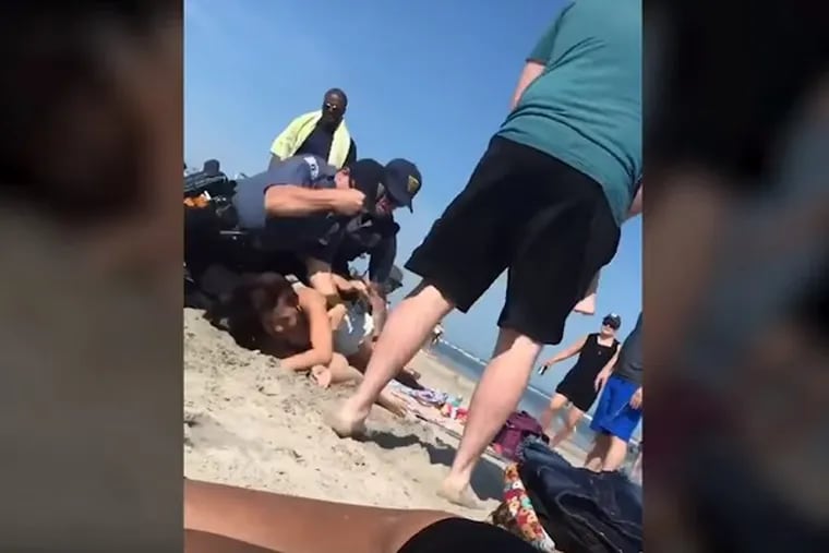 A video shows a Wildwood cop punching a woman in the head on Saturday afternoon.