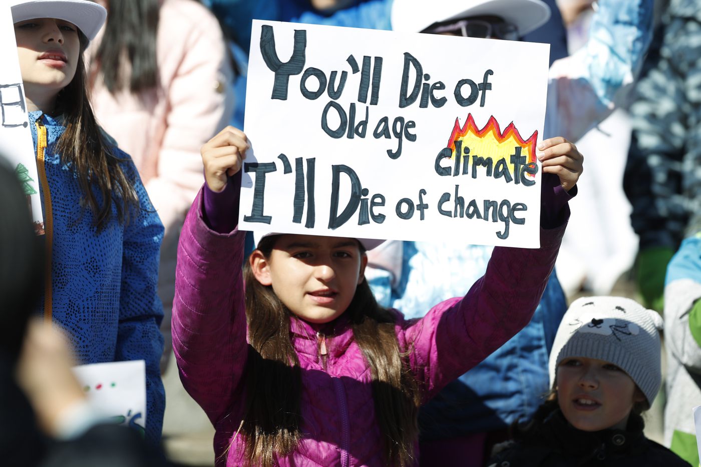 10-year-old Harper Phillips of Denver waves a placard as Swedish climate activist Greta Thunberg speaks to several thousand people at a climate strike rally Friday, Oct. 11, 2019, in Denver's Civic Center Park. 