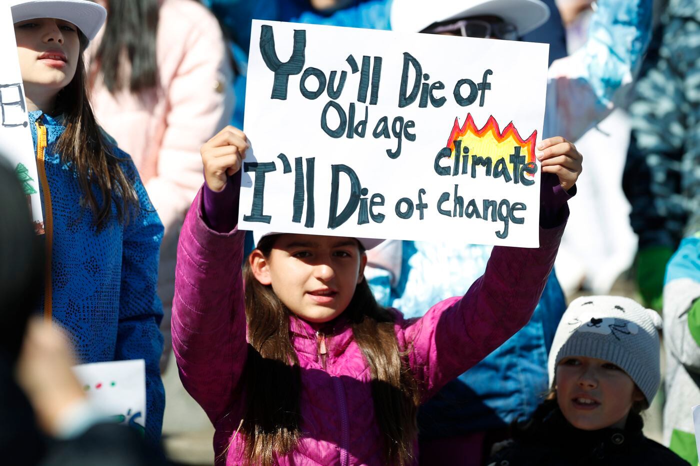 10-year-old Harper Phillips of Denver waves a placard as Swedish climate activist Greta Thunberg speaks to several thousand people at a climate strike rally Friday, Oct. 11, 2019, in Denver's Civic Center Park. 