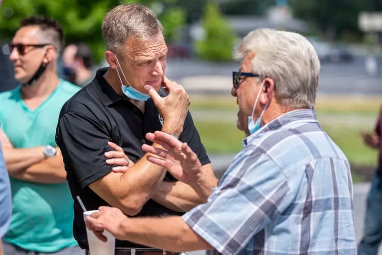 In this file photo from July 17, 2020, U.S. Rep. Scott Perry, left, R-Pa., speaks to Nick Loxas, owner of the Boomerang Comedy Zone in Lower Allen Township, Pa.  (Joe Hermitt/The Patriot-News via AP, File)