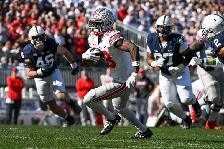Ohio State wide receiver Marvin Harrison Jr. runs away from Penn State defenders Nick Tarburton (46) and PJ Mustipher (97) during the first half Saturday.