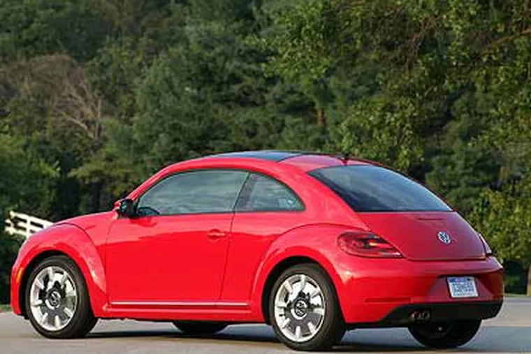 The 2012 VW Beetle. Its dash panel, shorter dashboard, and more-upright windshield hark back to the original.