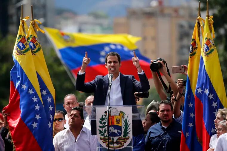 Juan Guaido, head of Venezuela's opposition-run congress, declares himself interim president of the nation until elections can be held during a rally demanding President Nicolas Maduro's resignation in Caracas, Venezuela, Wednesday, Jan. 23, 2019.