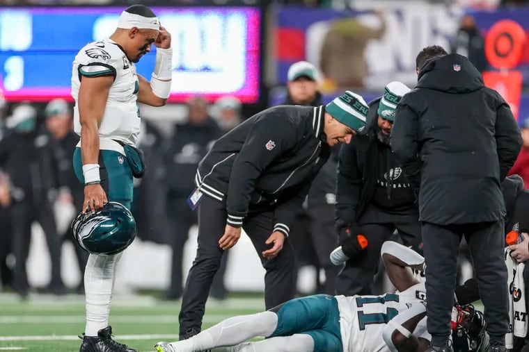 Eagles quarterback Jalen Hurts watches as Eagles wide receiver A.J. Brown is injured in the first quarter Sunday, Jan. 7, 2024, at MetLife Stadium in East Rutherford, N.J.