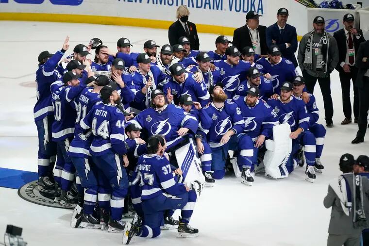 The Tampa Bay Lightning pose at center ice after defeating the Montreal Canadiens in Game 5 of the Stanley Cup Final.