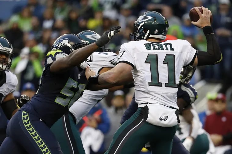 Carson Wentz will see a much more depleted defense in this year’s visit to Seattle. Cliff Avril, shown here about to force a fumble in last season’s game, is among the injured Seahawks who will not play Sunday night.