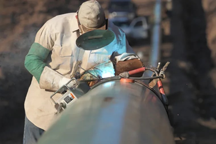 Federal pipeline-safety rules covering factors ranging from steel quality to welding standards do not apply in rural areas. Above, a welder works on a gathering pipe north of Wilkes-Barre. (Michael Bryant / Staff Photographer)