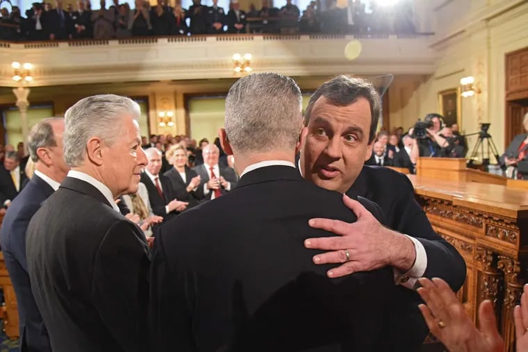 Christie hugs former Gov. Jim McGreevey before January's State of the State address, with former Gov. James Florio nearby. While many of the state's governors have seen poll numbers tumble, no other has seen such a wider swing.