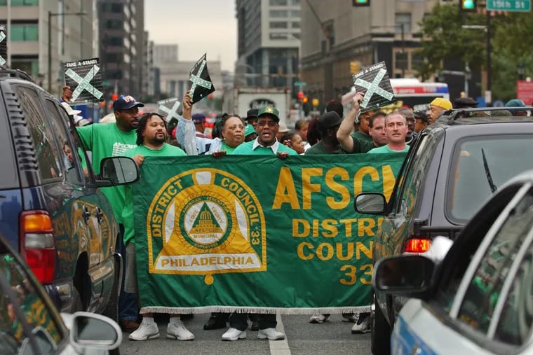 AFSCME District Council 33 members block Market Street in front of City Hall during a 2004 protest.