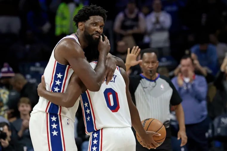 With just seconds to go in the game, Sixers center Joel Embiid hugs guard Tyrese Maxey after Maxey scored 50 points during their win over the Indiana Pacers.