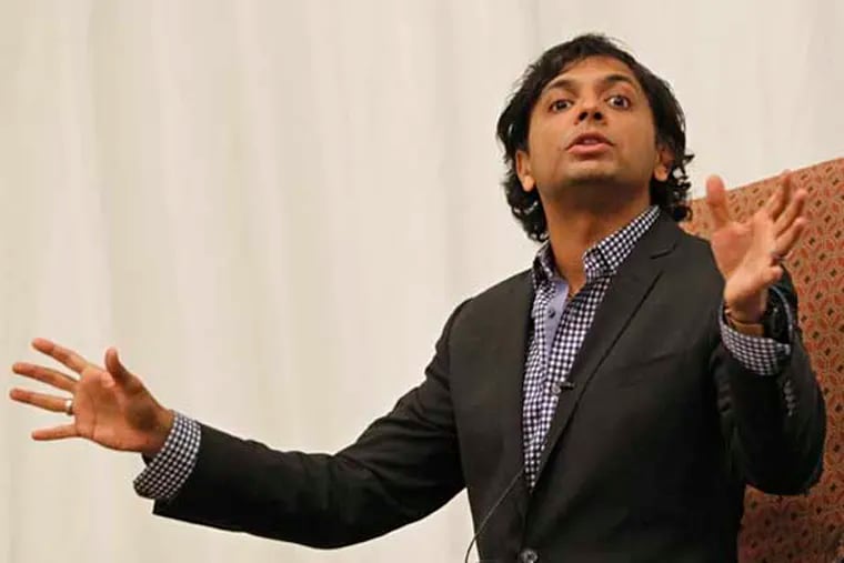Director M. Night Shyamalan sits in a chair in the front of a seated crowd of over 250 people in the Baldwin School's gymnasium and talks about his new book and his views of tackling the education gap in the United States. Director M. Night Shyamalan has veered off into a new direction - education. His book "I Got Schooled" gives his tips for improving America's education system. He speaks about the book and his ideas at Baldwin Academy with a group of local educators and then the public.  01/29/2014( MICHAEL BRYANT / Staff Photographer )