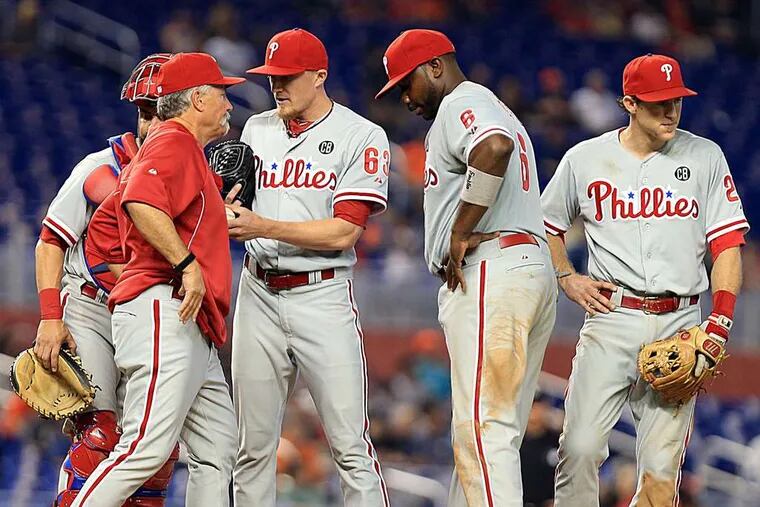 Pitching coach Bob McClure meets on the mound with Jake Diekman (63), Carlos Ruiz (obscured), Ryan Howard (6), and Chase Utley in the ninth. The Marlins ended it shortly thereafter.